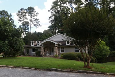 Exterior view of a senior living facility surrounded by trees