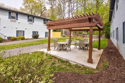 Outdoor patio area with seating and trees
