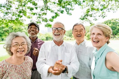 Group of smiling seniors enjoying time outdoors.