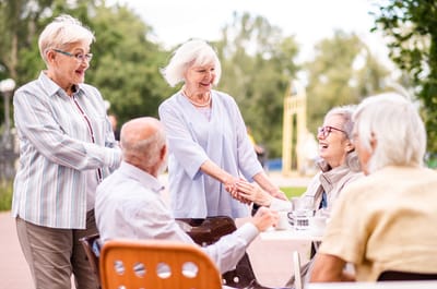 Residents engaging outdoors in a social activity.