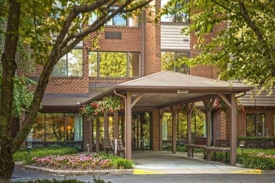Entrance with flowers and covered seating area