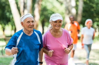 Seniors jogging together in a park