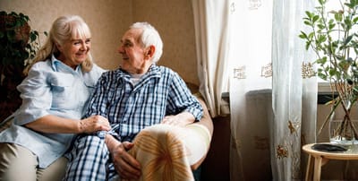 Elderly couple enjoying a moment together indoors.