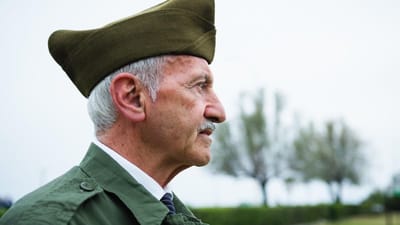 Elderly man in military attire outdoors