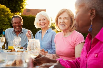 Residents enjoying a meal outdoors together.
