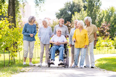Group of seniors enjoying a stroll in the garden