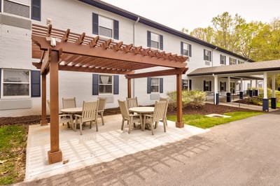 Outdoor seating area with tables and shade structure