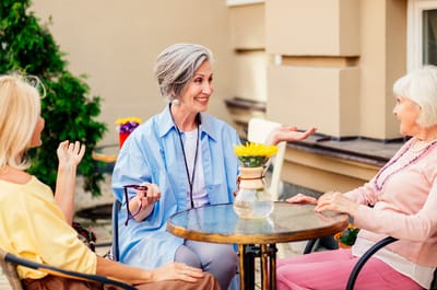 Residents enjoying conversation in an outdoor space.