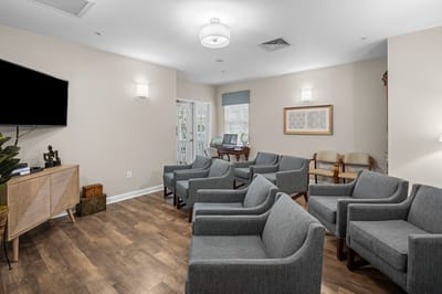 Cozy common area with seating and TVs.