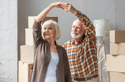 Happy elderly couple dancing together.