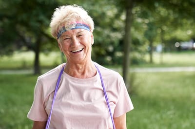 Smiling senior woman outdoors wearing exercise gear