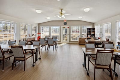 Common area with tables and chairs for residents