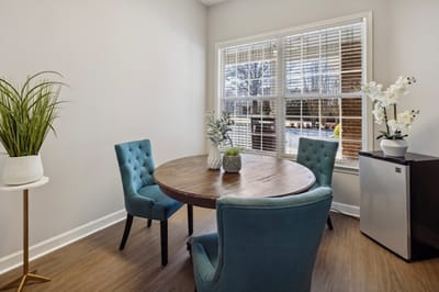 Bright, inviting common area with a round table and chairs