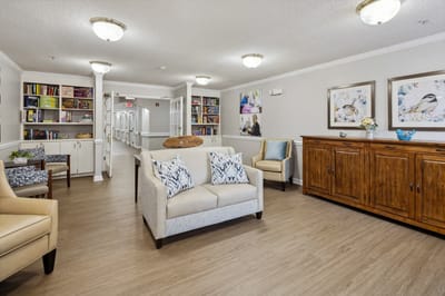 Cozy common area with seating and bookshelves.