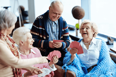 Residents playing cards in a lively common area