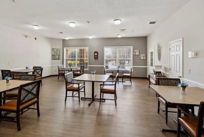 Dining area with tables and chairs set up.