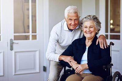 Senior couple smiling together in a care facility