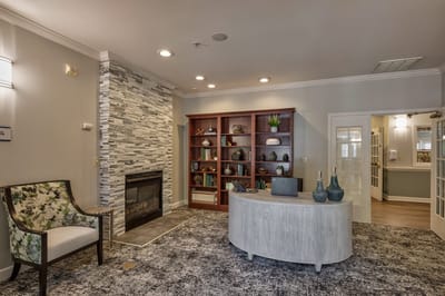 Cozy common area with a fireplace and bookshelves