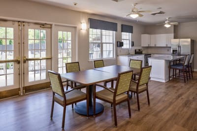 Common area with dining table and kitchen