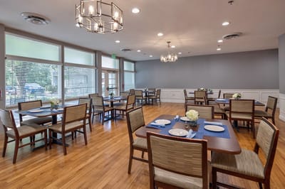 Bright dining room with tables set for meals.