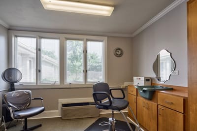 Interior view of a salon area with styling chairs.