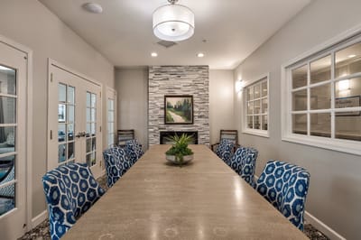 Bright and welcoming common area with a long table and chairs.