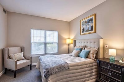 Cozy resident bedroom with comfortable furnishings.