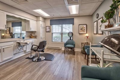 Interior view of a salon area with chairs and mirrors.