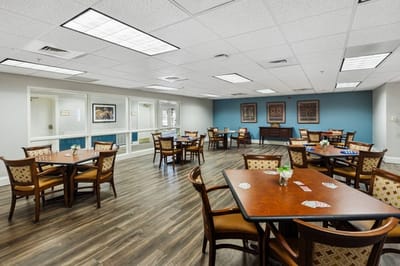 Dining area with tables and chairs.