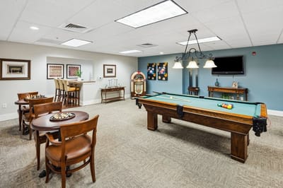 Common area with pool table and seating.