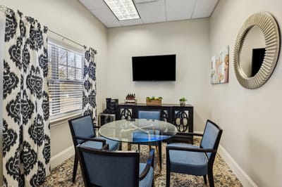 Cozy common area with a glass table and chairs.