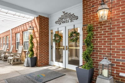 Welcoming entrance with decorative plants and seating.