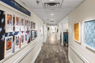 Hallway decorated with framed photos and artwork.
