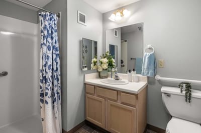 Bright bathroom with floral decor and modern fixtures