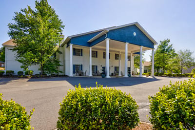 Exterior view of the facility with lush landscaping.