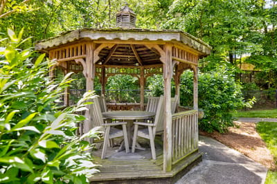Wooden gazebo in a lush garden setting