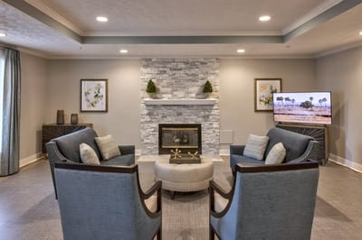 Cozy common area with modern seating and a fireplace.