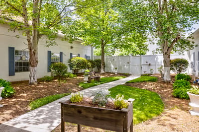 Well-maintained outdoor garden area with walking paths.