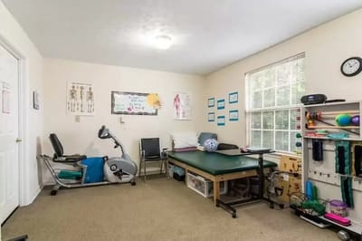 Physical therapy room with equipment and decor
