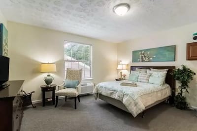 Cozy resident room with bed and chair