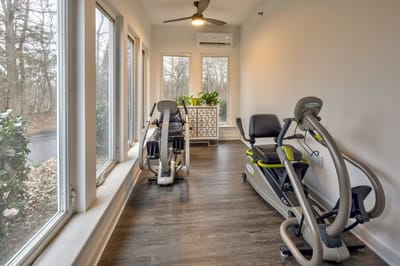 Exercise equipment in a bright, airy fitness room.