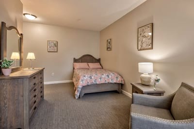Cozy private resident room with a bed and dresser.
