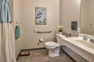 Clean bathroom with a decorative painting.