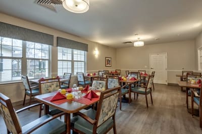 Dining room with tables set for a meal.