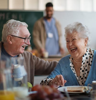 Happy residents enjoying a meal together