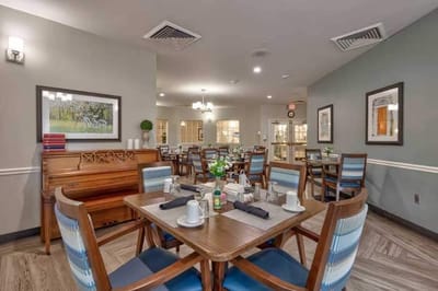 Dining area with tables and a piano