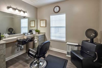 Salon area with styling chairs and mirror
