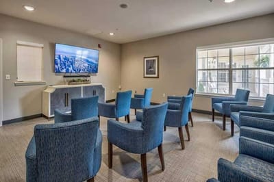 Common area with seating and TV in the facility.