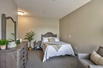 Cozy resident room with a bed and seating area