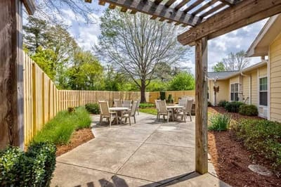 Outdoor seating area with chairs and table.